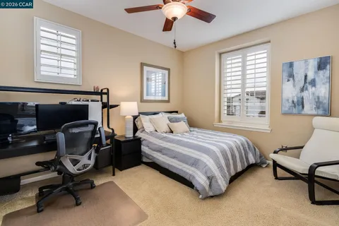 a bedroom with a bed chair and a window