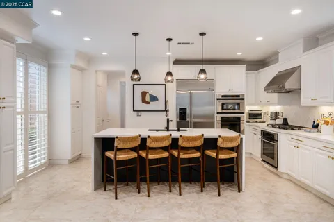 a large kitchen with a table and chairs