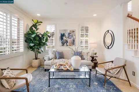 a living room with furniture flowerpot and window
