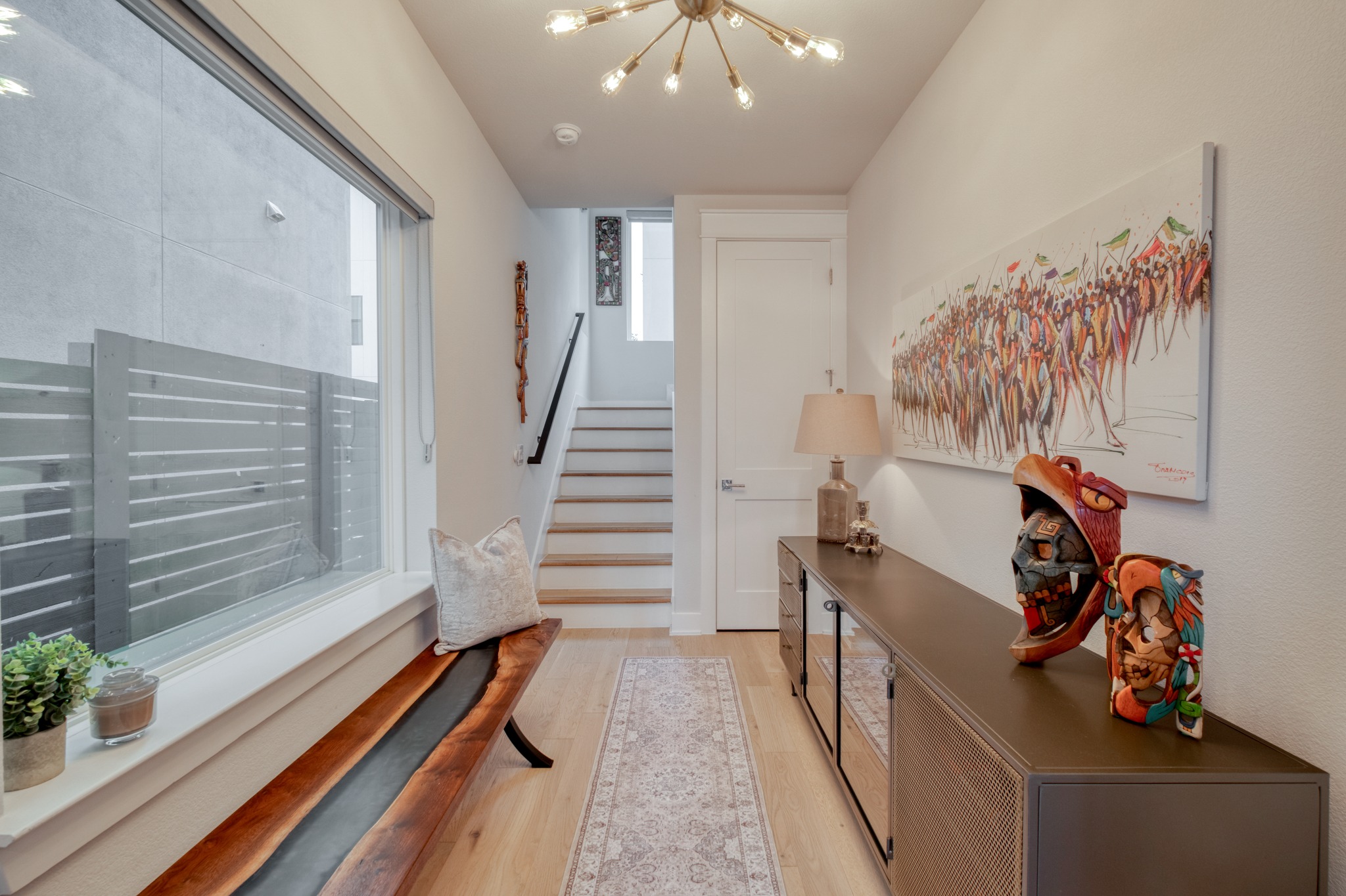 5002 Pecan Springs Road, Unit 7 Austin, TX 78723 - Photo 5 of 34 A large window to the left floods the entry with natural light, highlighting the engineered hardwood floors that run throughout the home