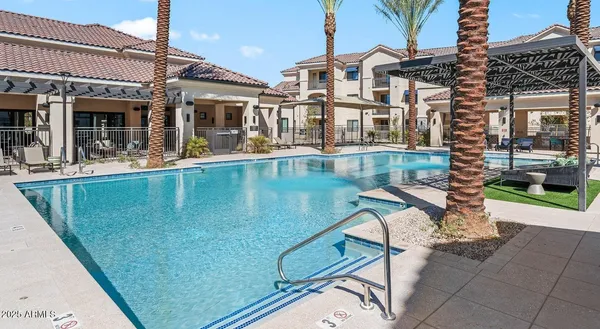 a view of a patio with swimming pool table and chairs