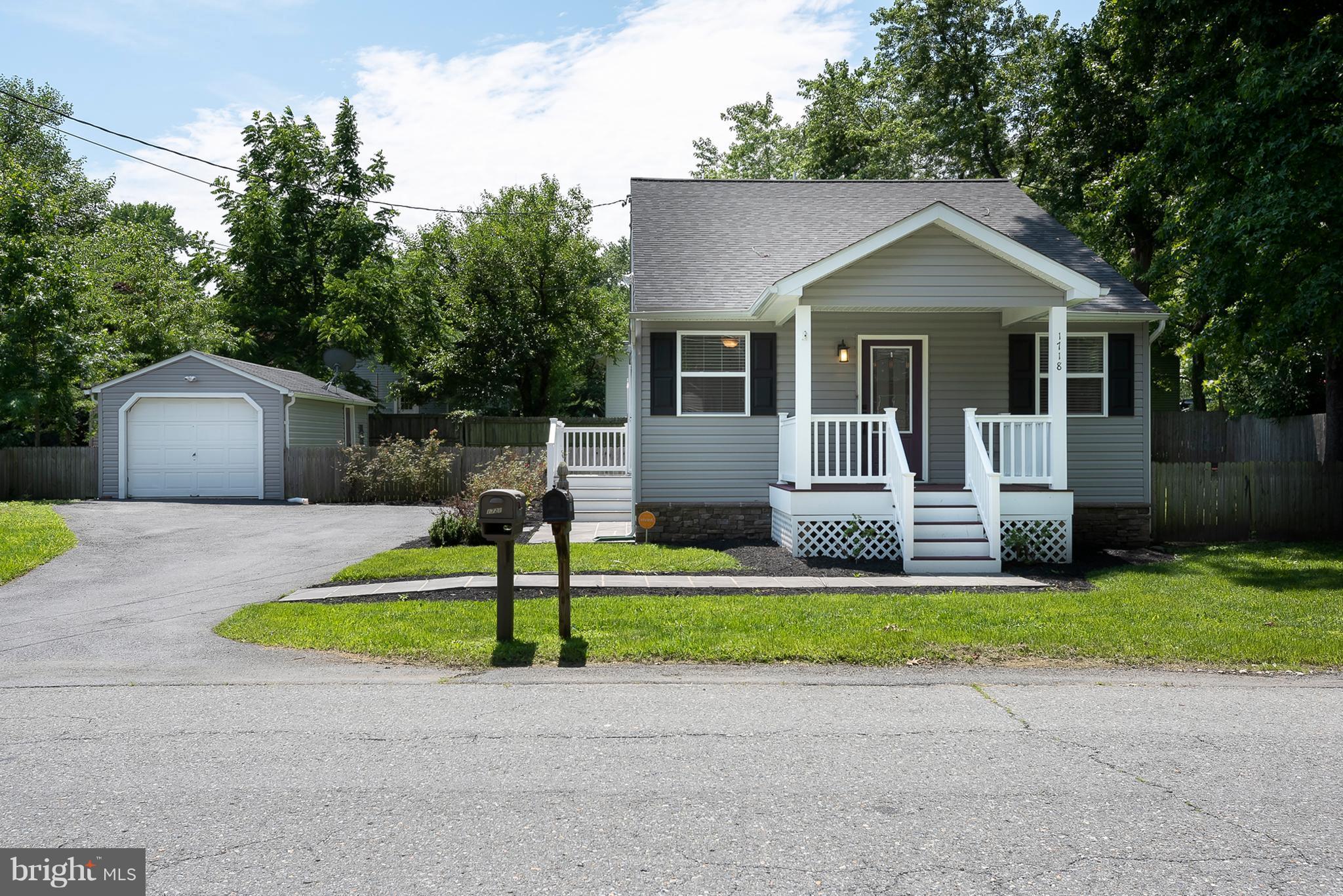 1718 Tacoma Road Edgewater, MD 21037 - Photo 1 of 30 a front view of a house with a yard and garage