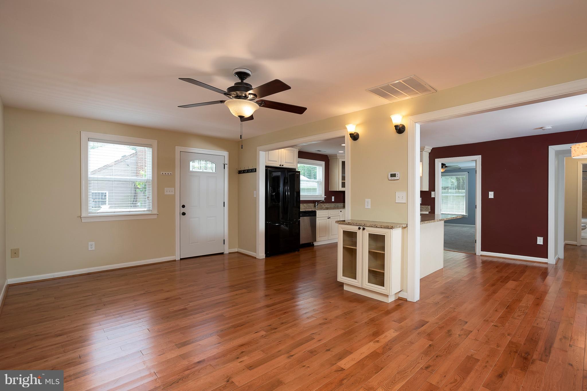 1718 Tacoma Road Edgewater, MD 21037 - Photo 11 of 30 a view of a big room with wooden floor and a kitchen