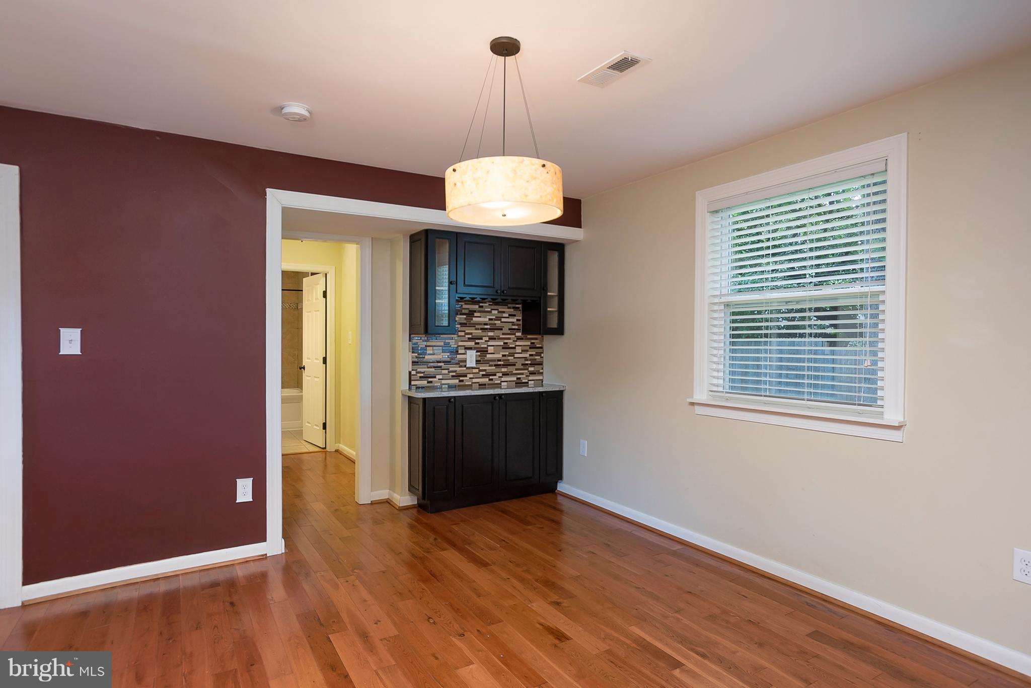 1718 Tacoma Road Edgewater, MD 21037 - Photo 12 of 30 a view of an empty room with wooden floor and a window