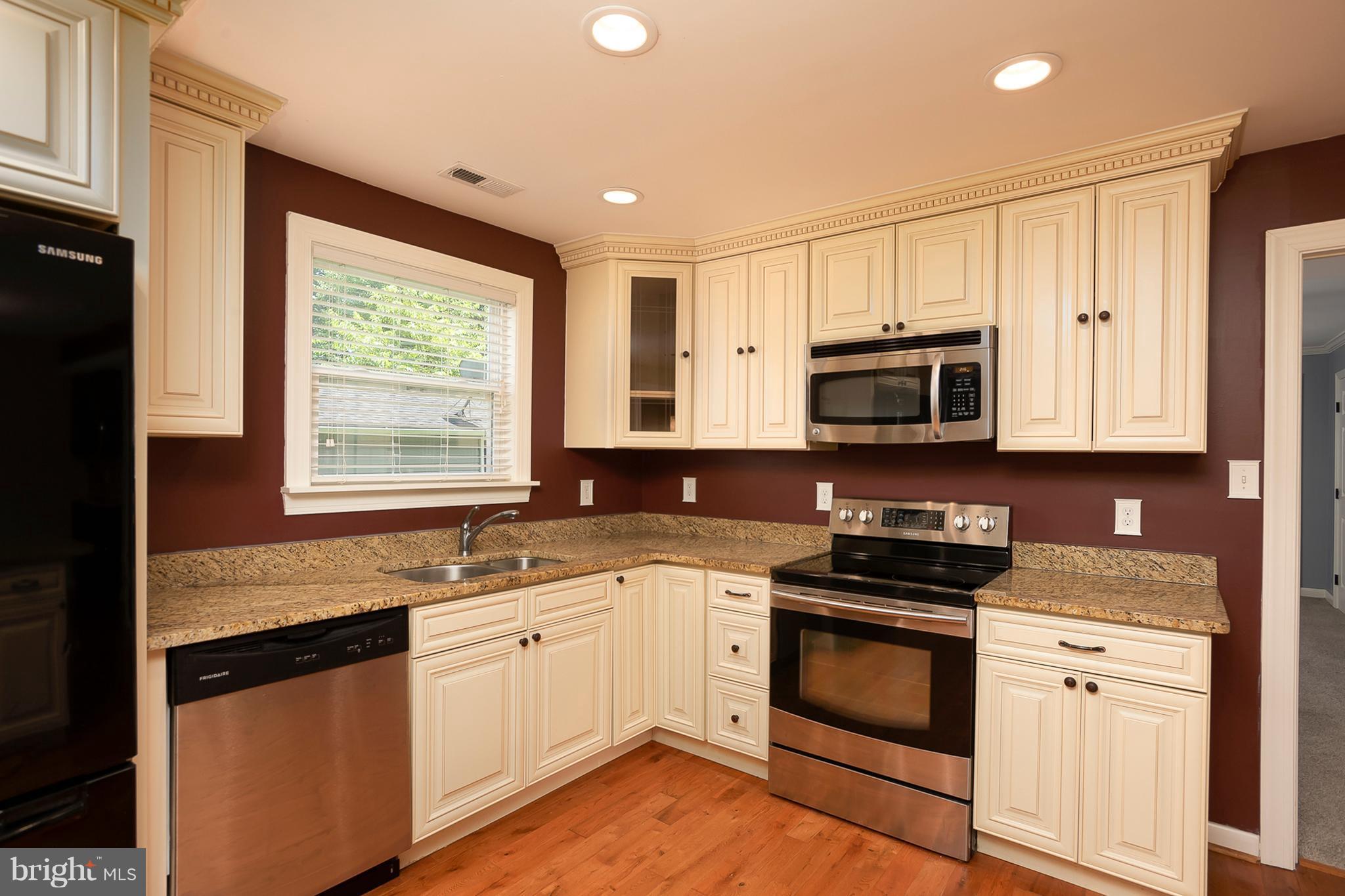 1718 Tacoma Road Edgewater, MD 21037 - Photo 15 of 30 a kitchen with granite countertop white cabinets appliances a sink and a window