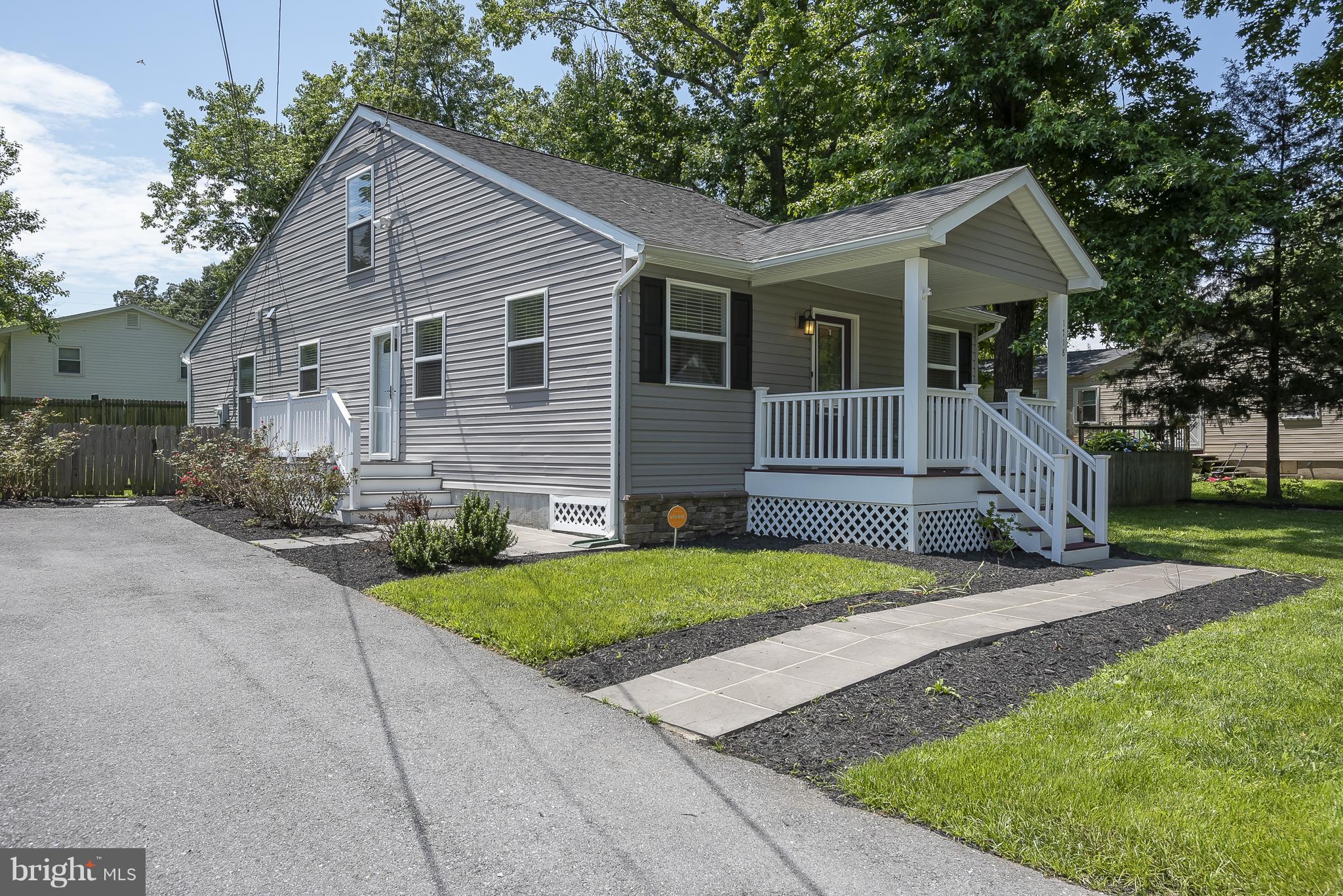 1718 Tacoma Road Edgewater, MD 21037 - Photo 3 of 30 a front view of a house with a garden and trees
