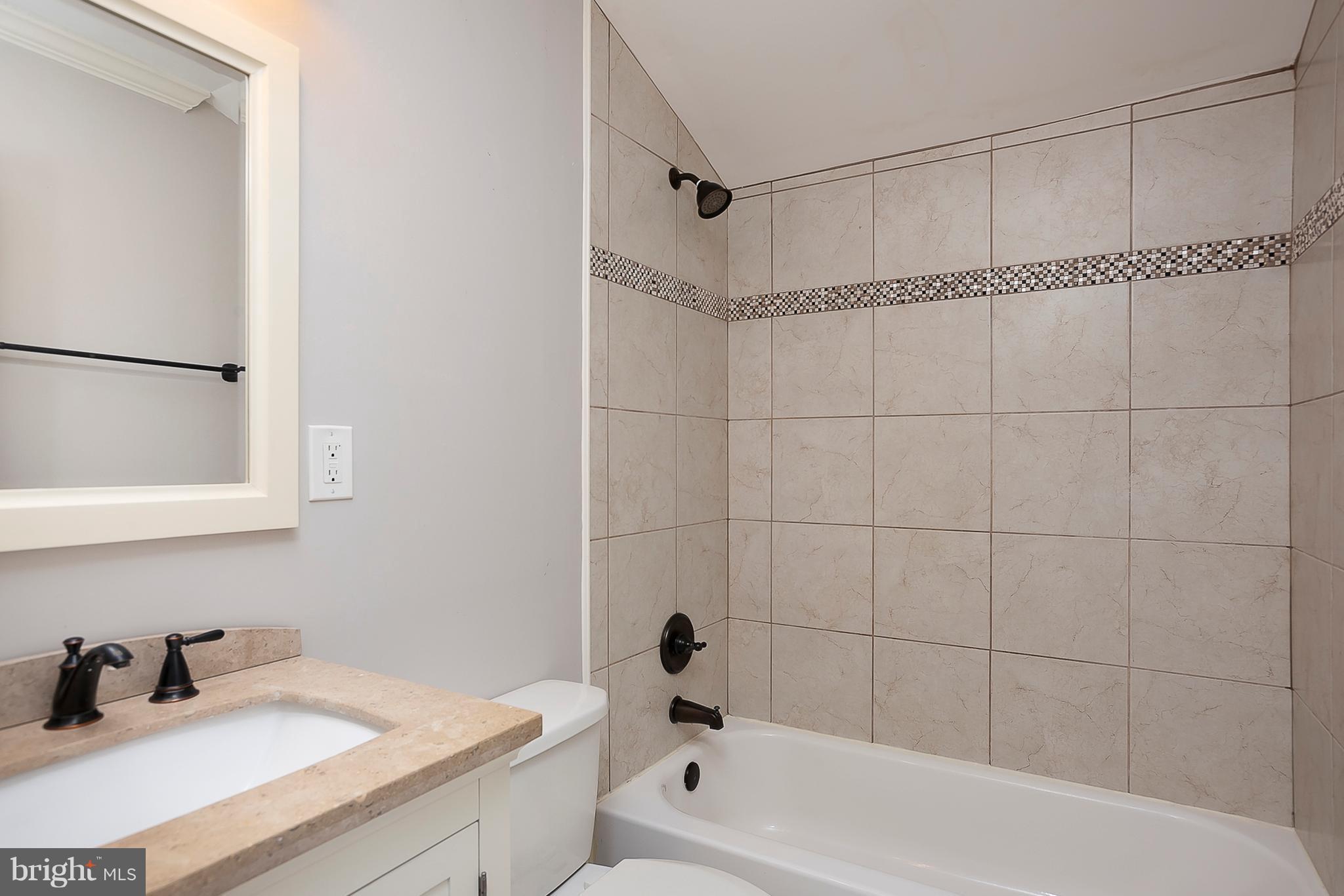 1718 Tacoma Road Edgewater, MD 21037 - Photo 22 of 30 a bathroom with a bathtub a sink a vanity and a shower