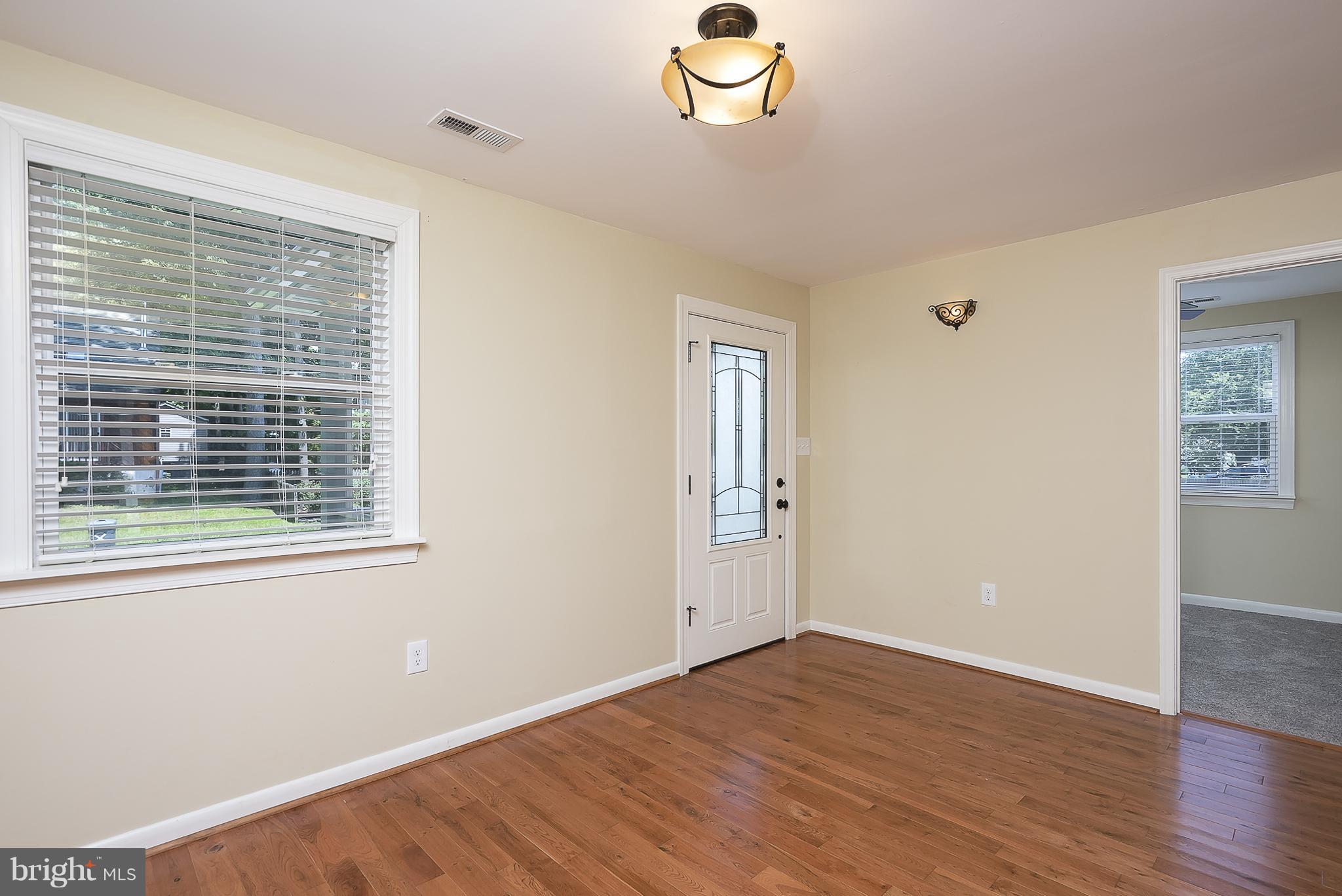 1718 Tacoma Road Edgewater, MD 21037 - Photo 7 of 30 a view of an empty room with wooden floor and a window