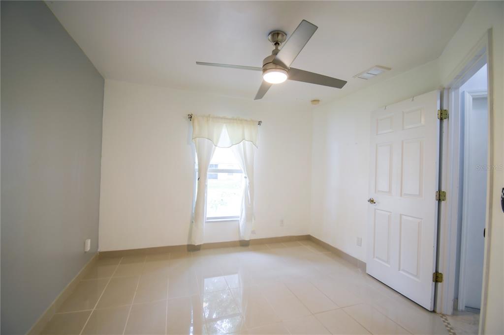 4913 Cromey Road North Port, FL 34288 - Photo 18 of 26 an empty room with closet and windows