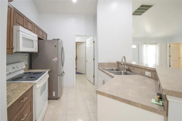 a kitchen with a sink stove and refrigerator