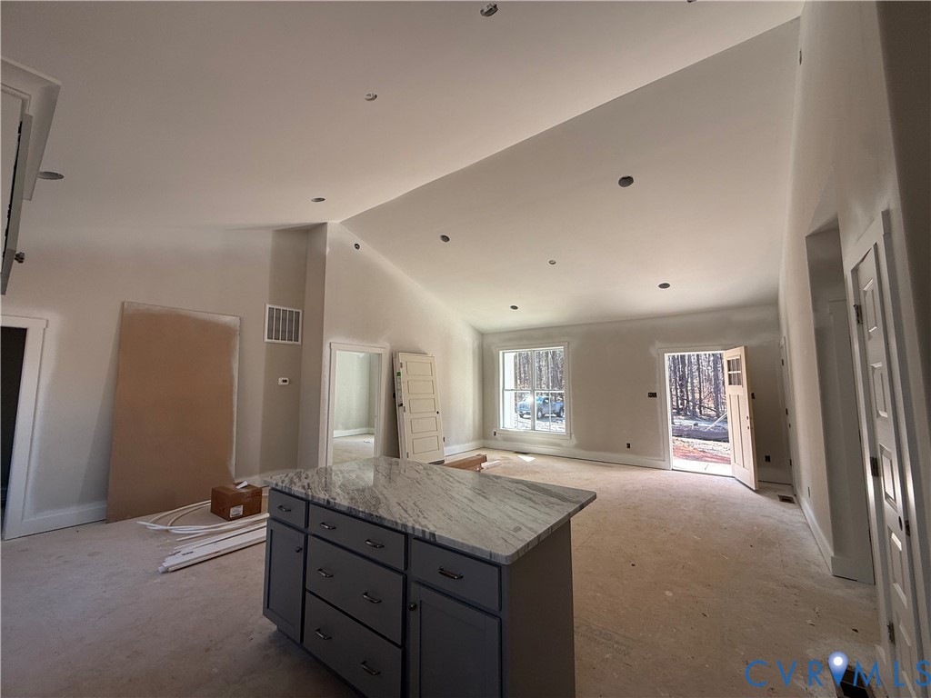 295 Merifield Drive Clarksville, VA 23927 - Photo 18 of 32 a spacious bathroom with a granite countertop sink a mirror and a shower