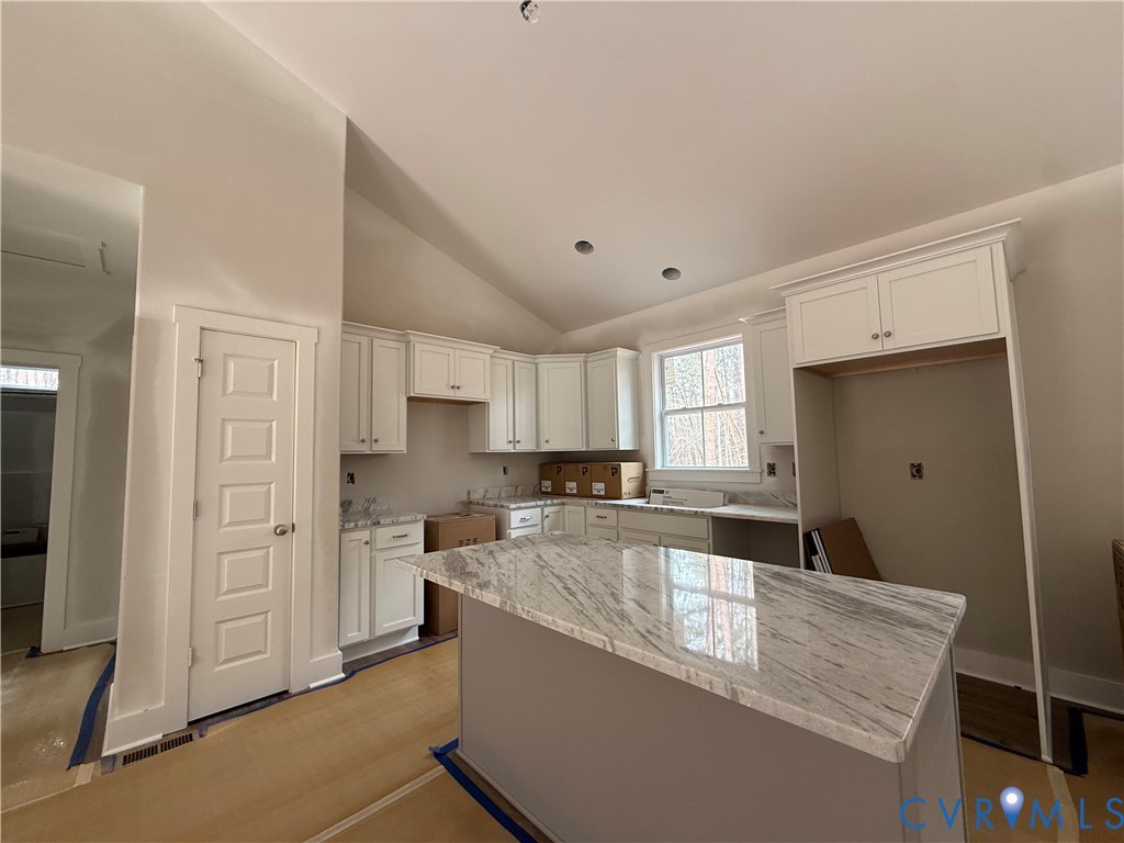 295 Merifield Drive Clarksville, VA 23927 - Photo 25 of 32 a large kitchen with kitchen island a sink stainless steel appliances and cabinets