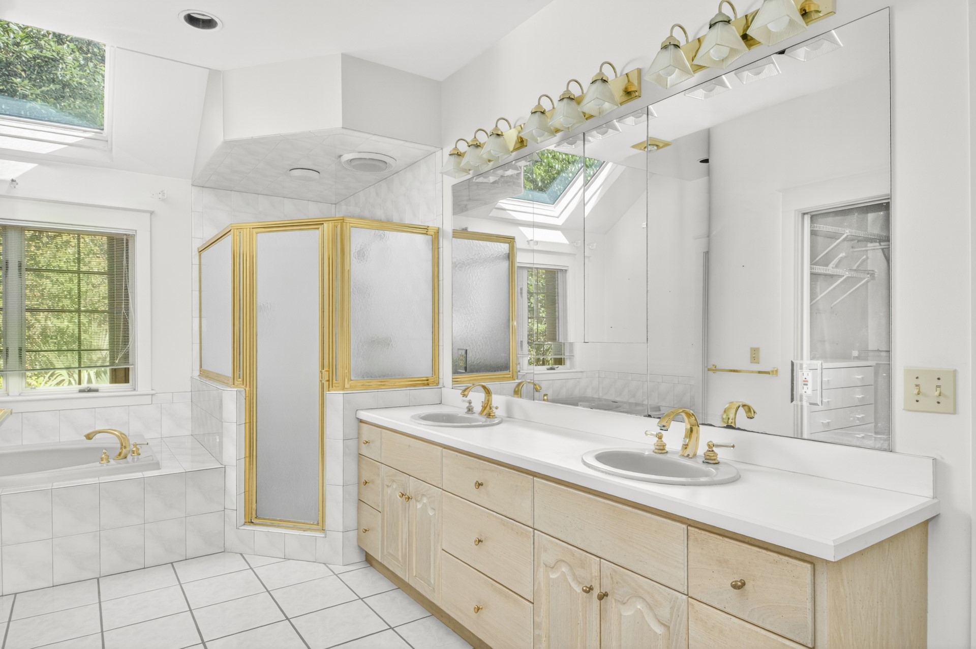 7 Hickory Lane Fernandina Beach, FL 32034 - Photo 23 of 42 a bathroom with a granite countertop sink a large mirror and a bathtub next to a window