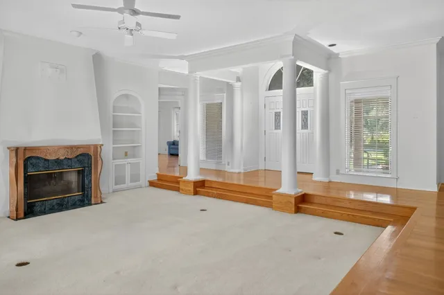 a kitchen with a stove white cabinets and white appliances