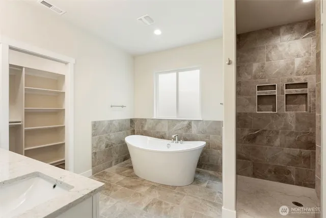 a spacious bathroom with a bathtub and shower