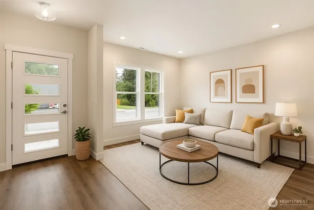 a living room with furniture potted plant and a window