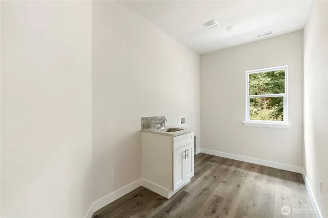 an empty room with wooden floor