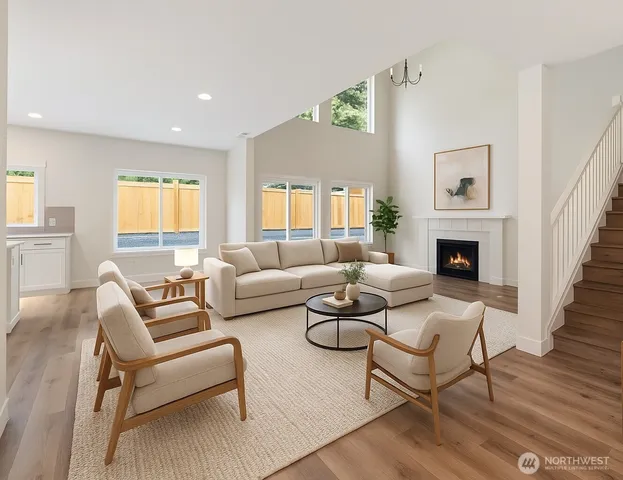 a living room with fireplace furniture and a wooden floor