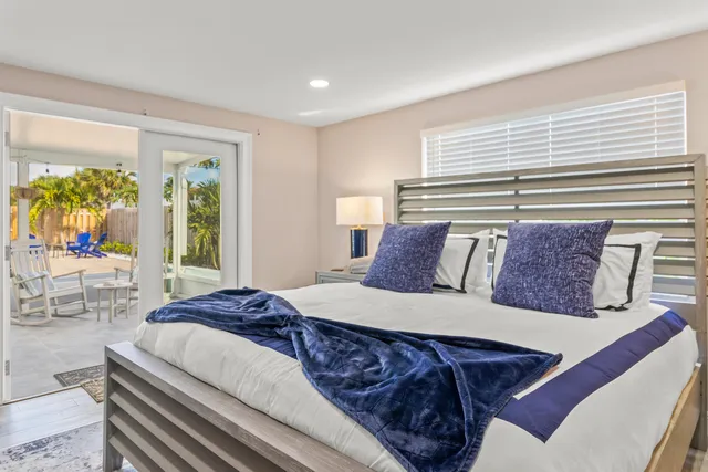 a bed sitting in a bedroom next to a window