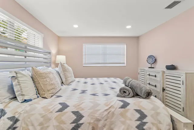 a bedroom with a large bed and a window