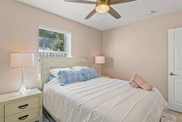 a bedroom with a bed and a window