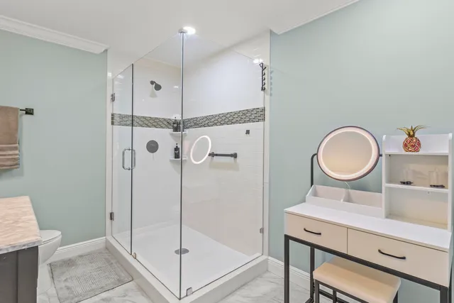 a bathroom with a sink mirror vanity and a shower
