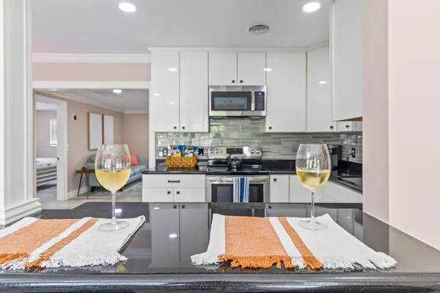 a kitchen with stainless steel appliances granite countertop a stove top oven a sink a counter space and cabinets