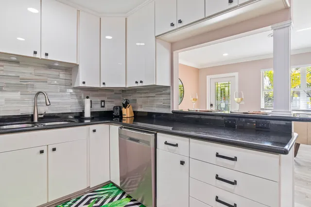 a kitchen with stainless steel appliances white cabinets and a sink