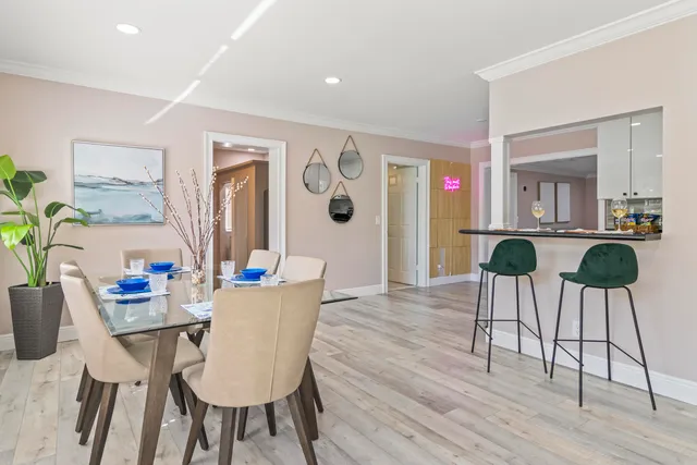 a view of a dining room with furniture and wooden floor