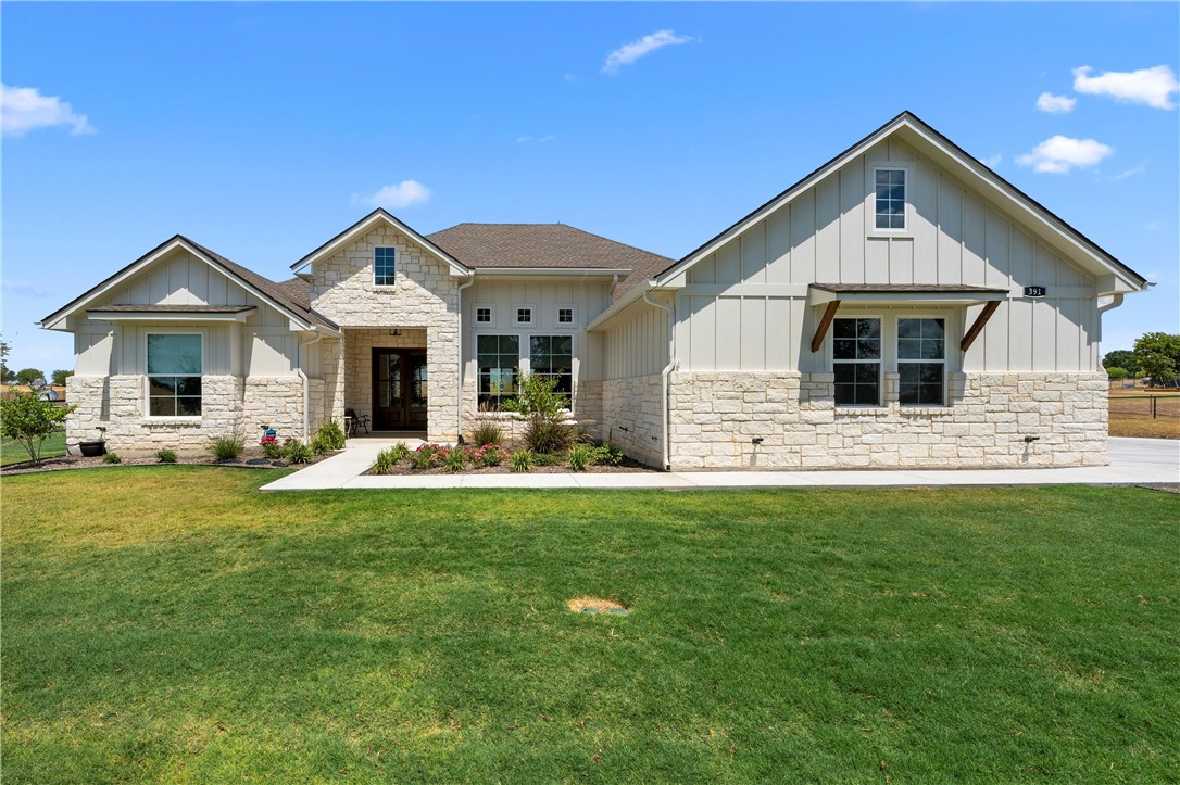 a front view of house with yard and green space