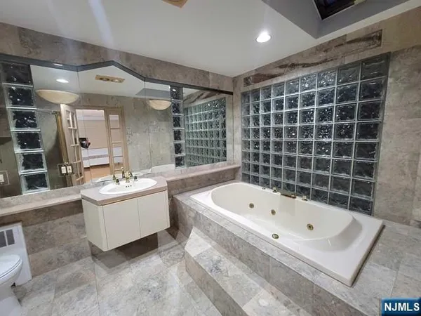 a bathroom with a bathtub and a sink
