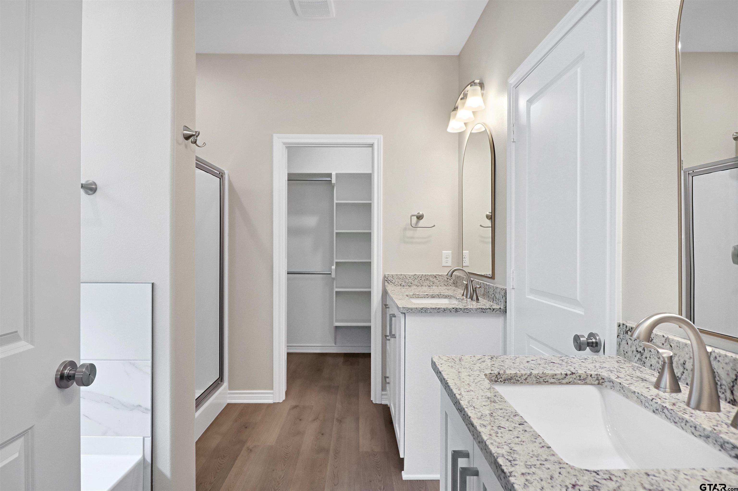 3053 Guinn Farms Road Tyler, TX 75707 - Photo 19 of 32 a bathroom with a granite countertop sink shower and a mirror