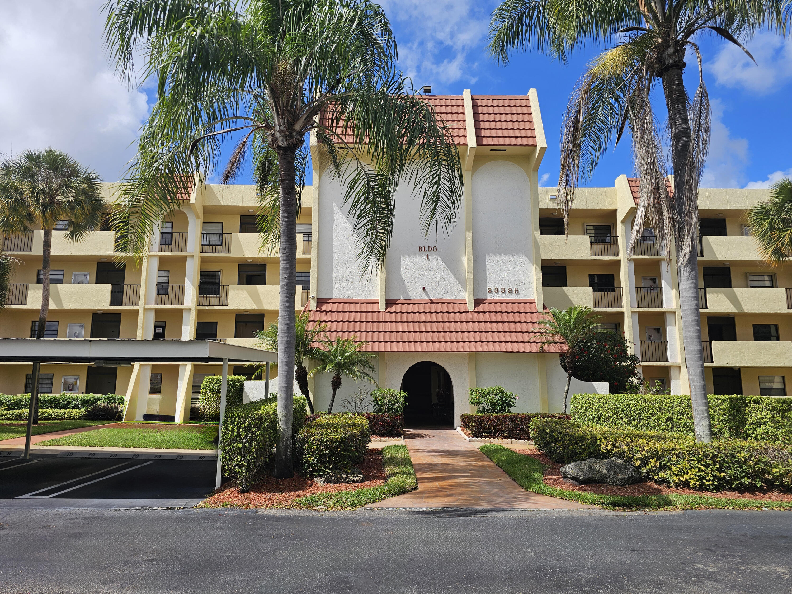 23385 South Barwood Lane, Unit 1203 Boca Raton, FL 33428 - Photo 1 of 22 front view of a building with a street