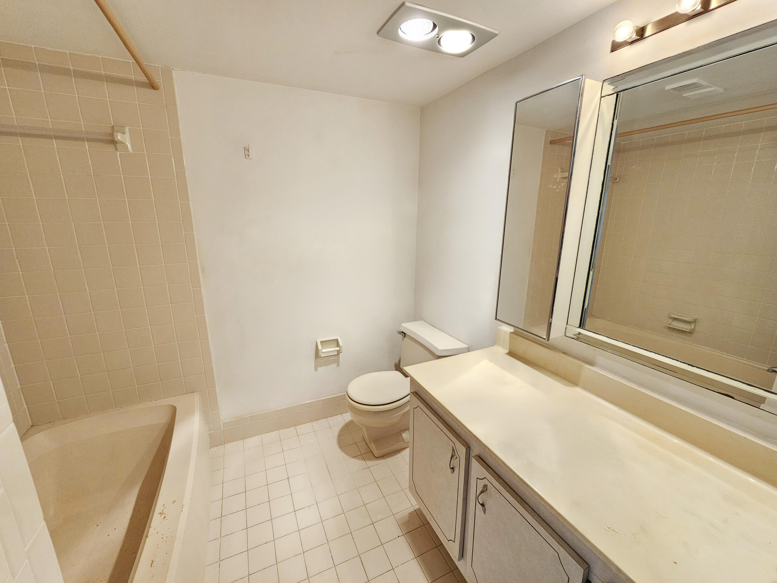 23385 South Barwood Lane, Unit 1203 Boca Raton, FL 33428 - Photo 12 of 22 a bathroom with a granite countertop sink toilet and shower