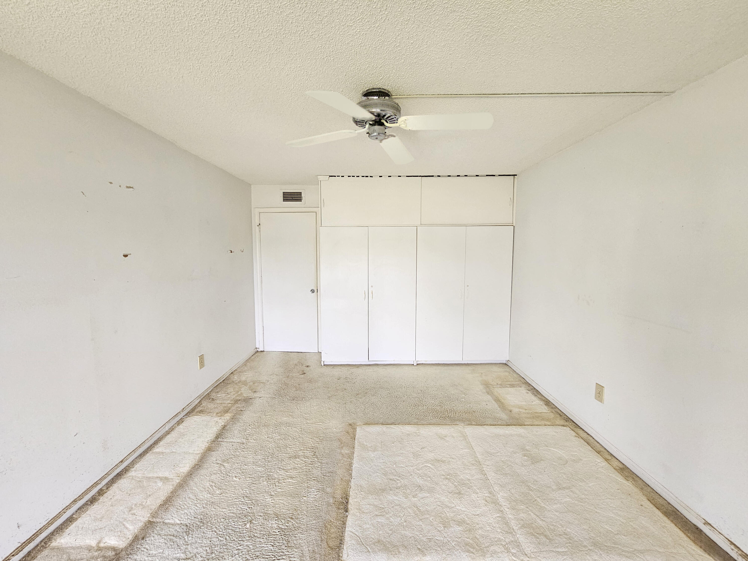 23385 South Barwood Lane, Unit 1203 Boca Raton, FL 33428 - Photo 14 of 22 an empty room with a ceiling fan