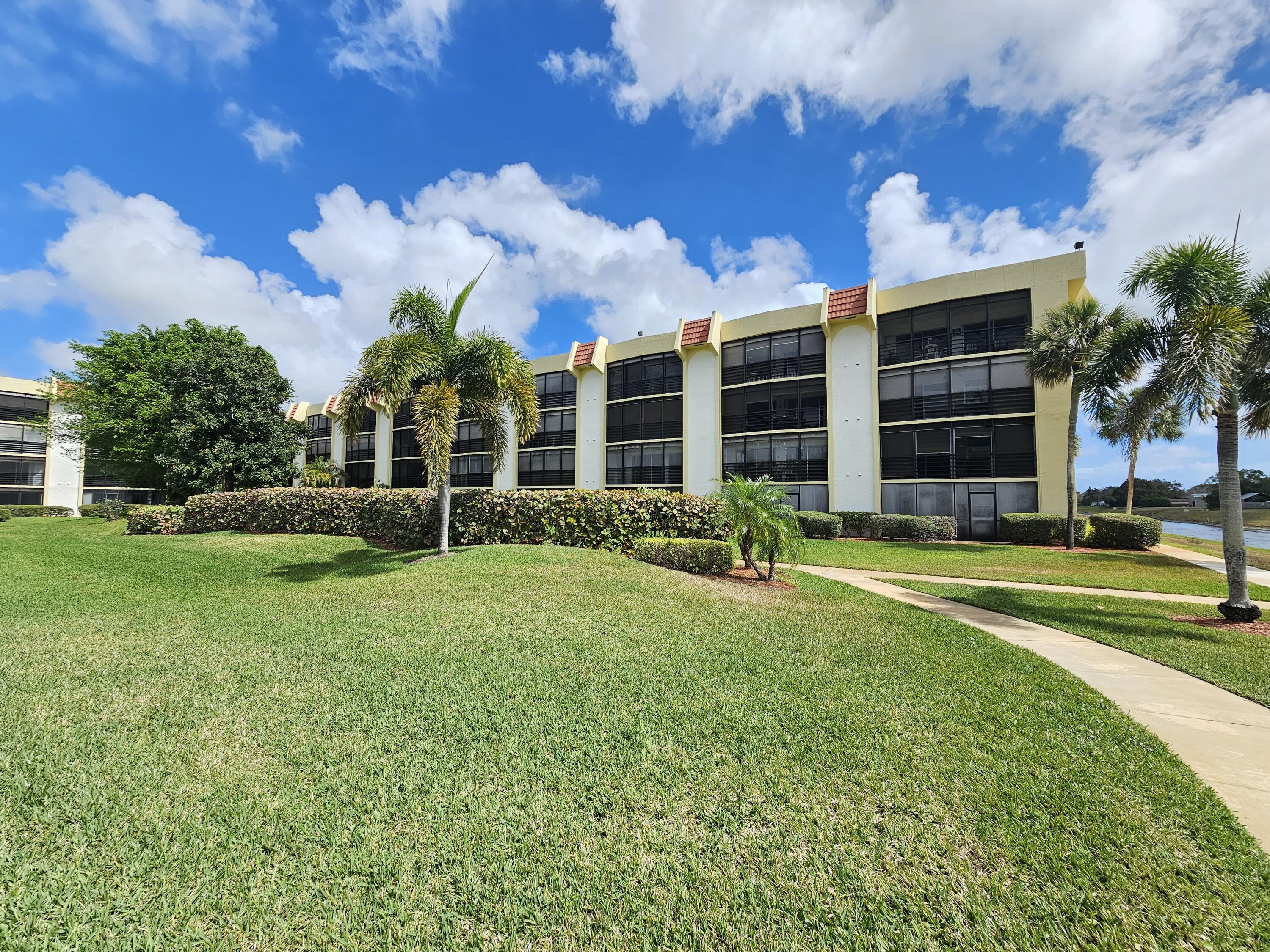 23385 South Barwood Lane, Unit 1203 Boca Raton, FL 33428 - Photo 22 of 22 a view of a house with a yard and a large tree
