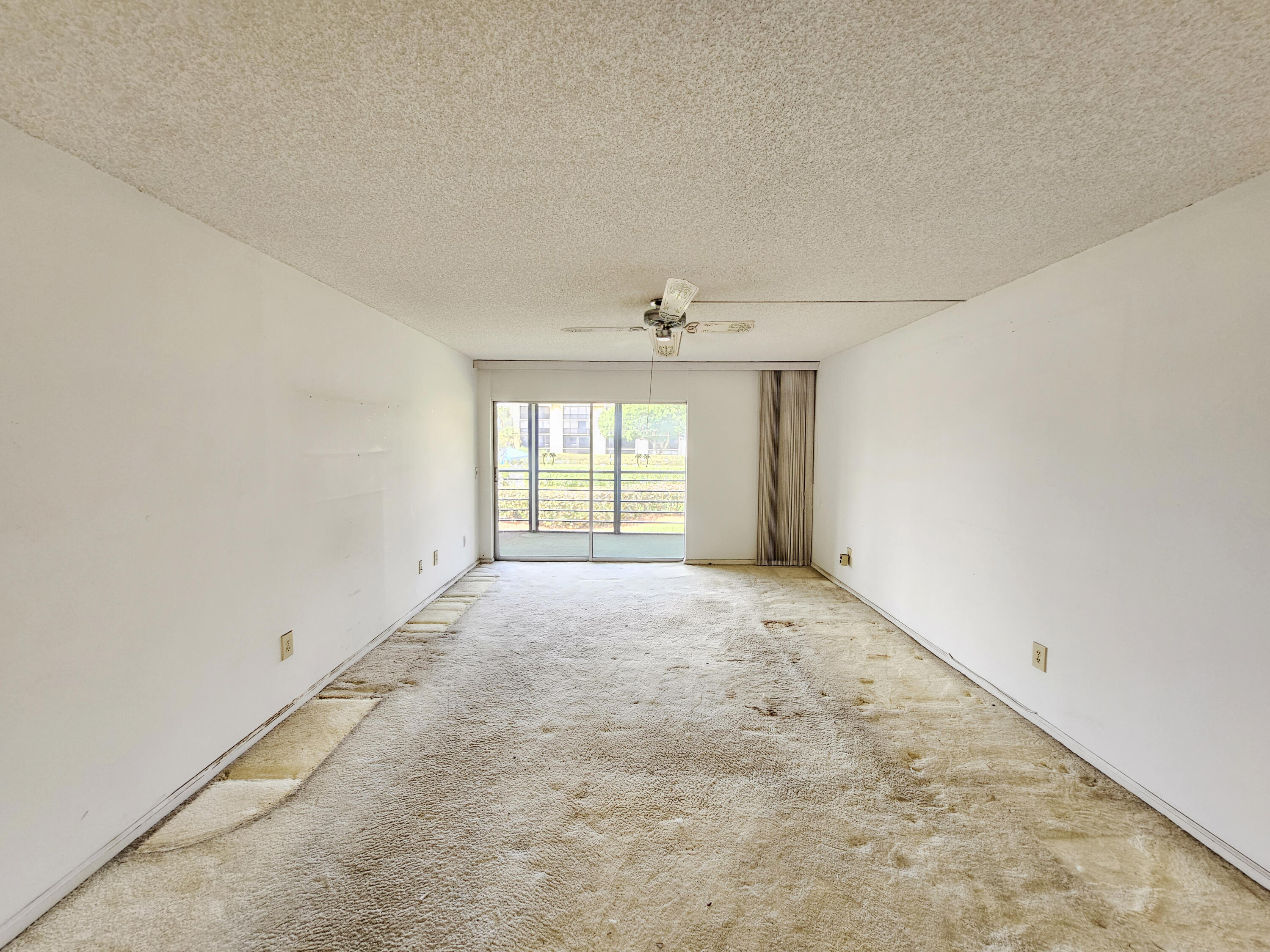 23385 South Barwood Lane, Unit 1203 Boca Raton, FL 33428 - Photo 4 of 22 an empty room with a empty space and windows