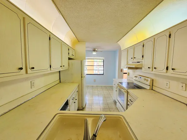 a kitchen with stainless steel appliances granite countertop a sink and cabinets