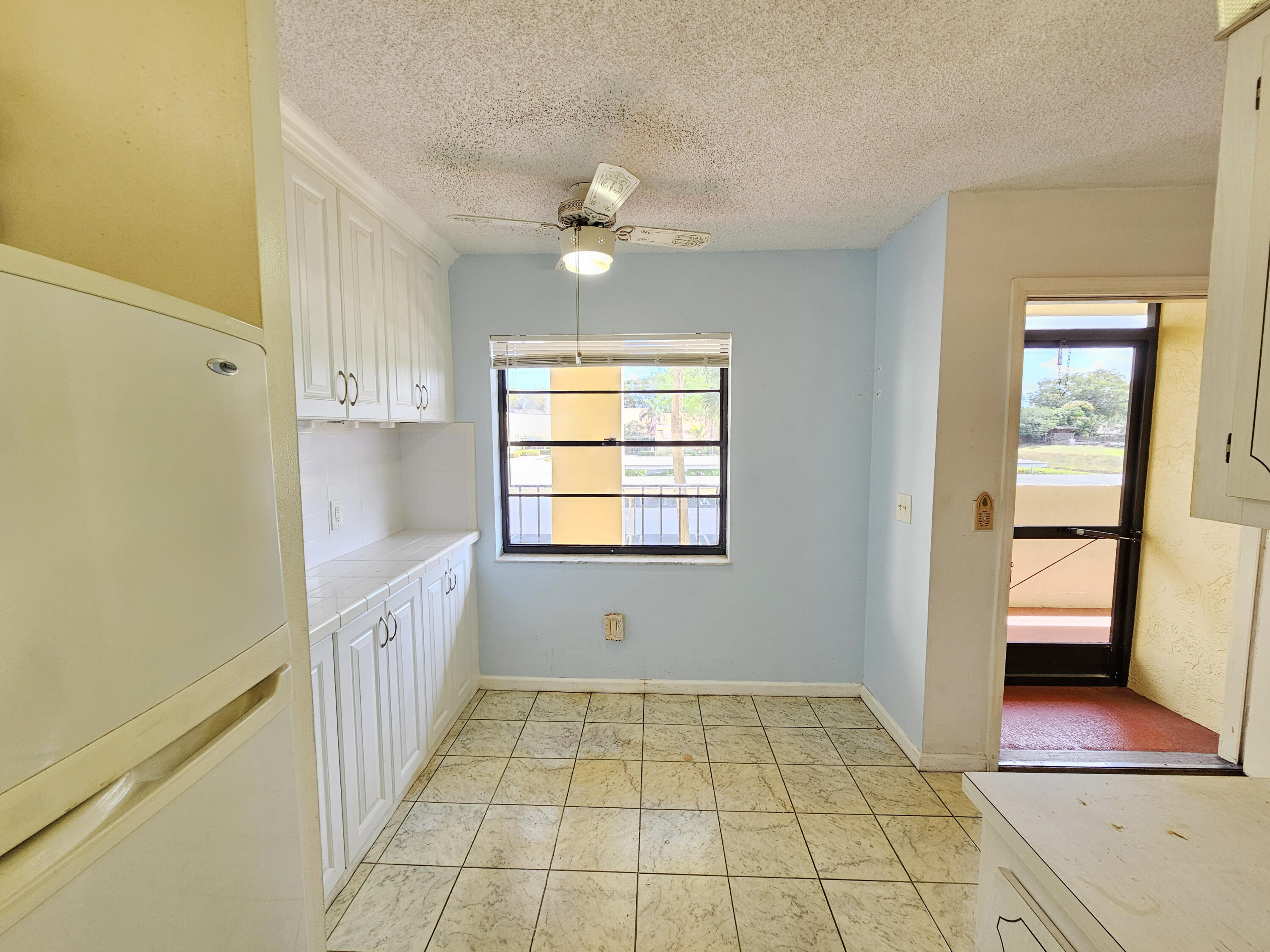 23385 South Barwood Lane, Unit 1203 Boca Raton, FL 33428 - Photo 9 of 22 a view of an empty room with window and wooden floor