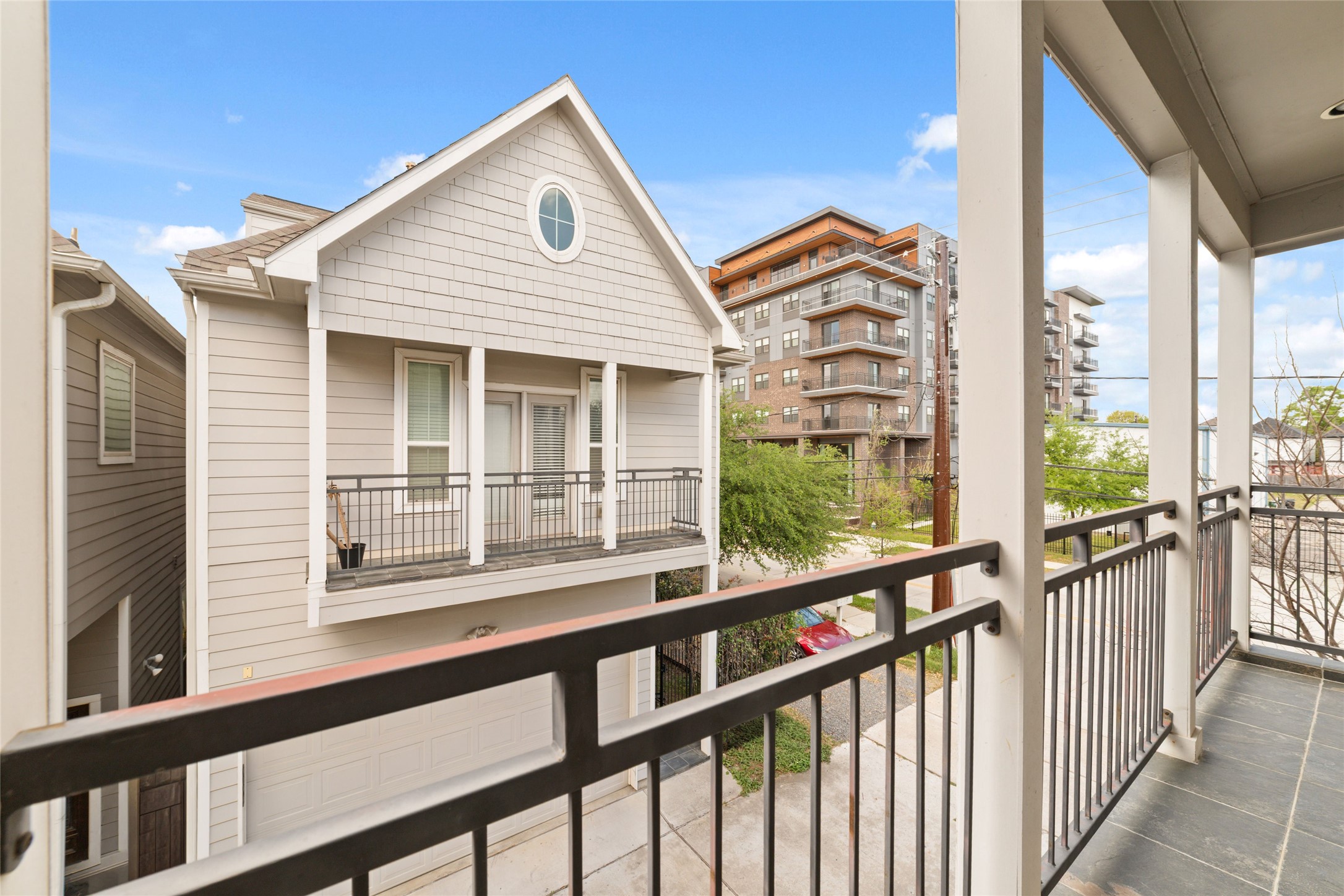 902 West 20th Street, Unit A Houston, TX 77008 - Photo 18 of 23 a view of a balcony with a large window and wooden fence