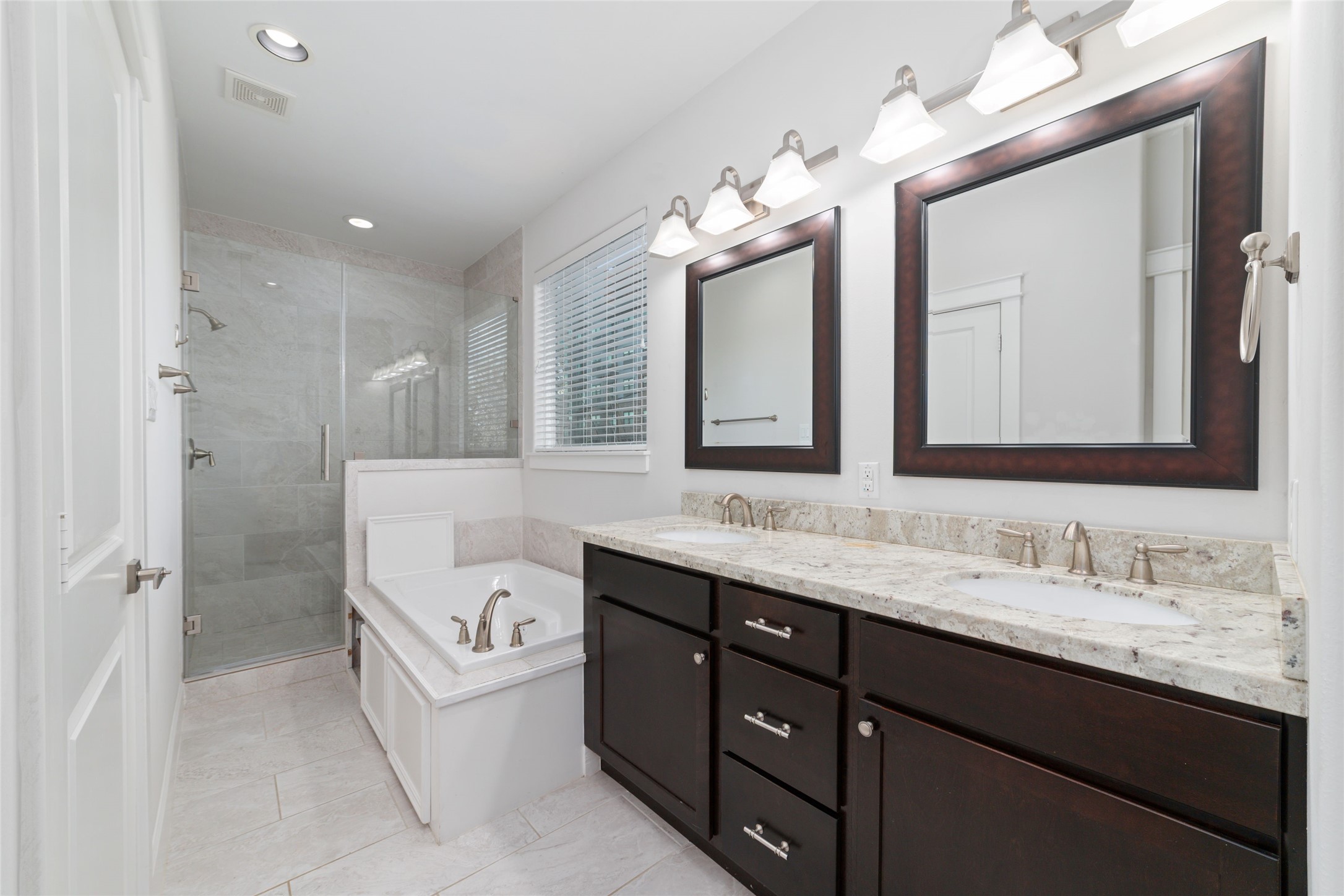 902 West 20th Street, Unit A Houston, TX 77008 - Photo 19 of 23 a spacious bathroom with a granite countertop sink a toilet a mirror and shower