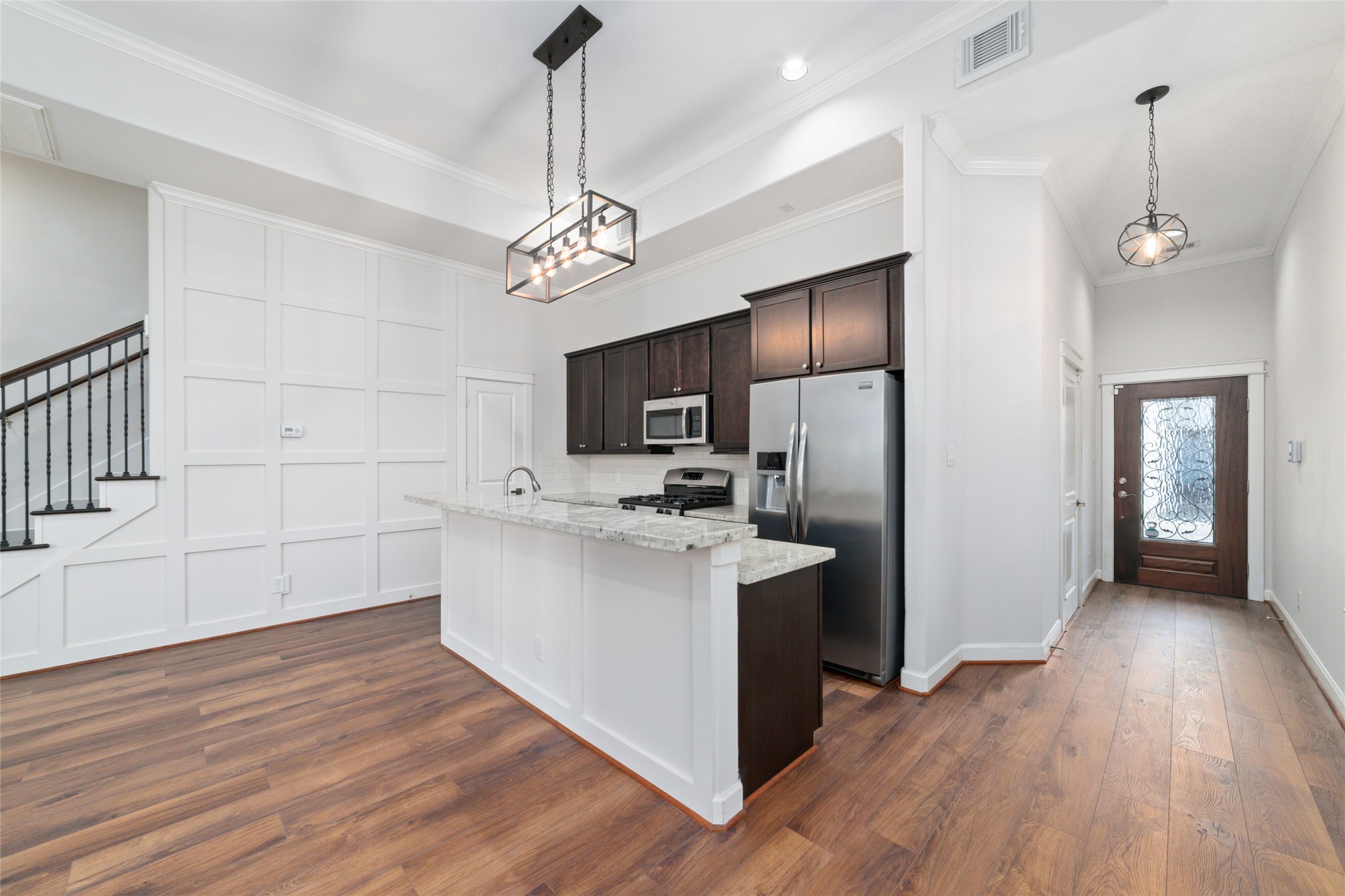 902 West 20th Street, Unit A Houston, TX 77008 - Photo 3 of 23 a view of a kitchen with a sink a ceiling fan and stainless steel appliances