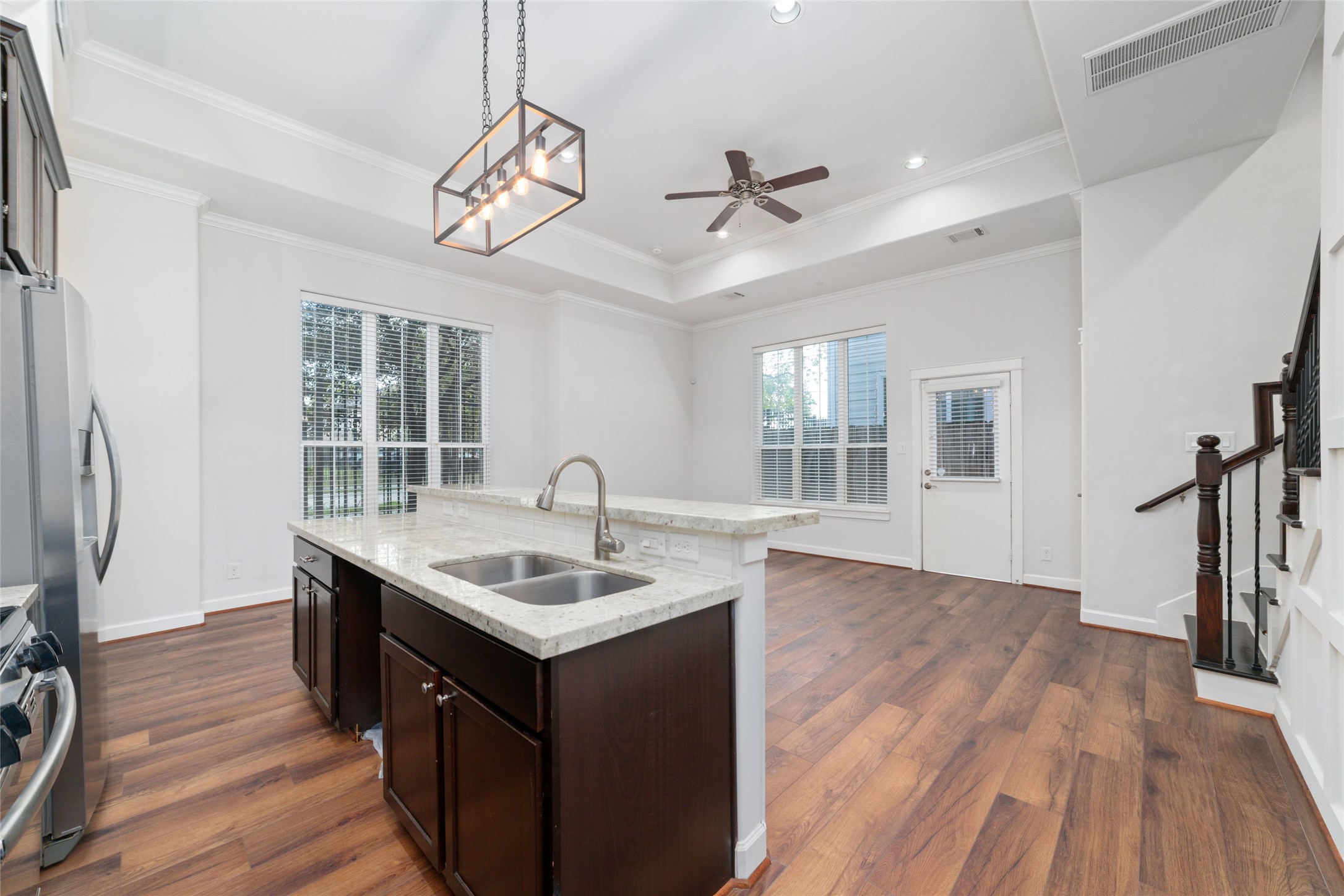 902 West 20th Street, Unit A Houston, TX 77008 - Photo 5 of 23 a kitchen with a sink chandelier and wooden floor