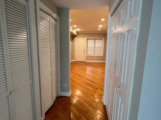 a view of empty room with wooden floor