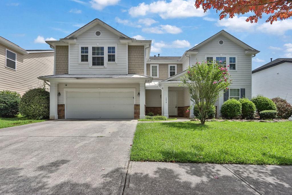 a front view of a house with a yard and garage