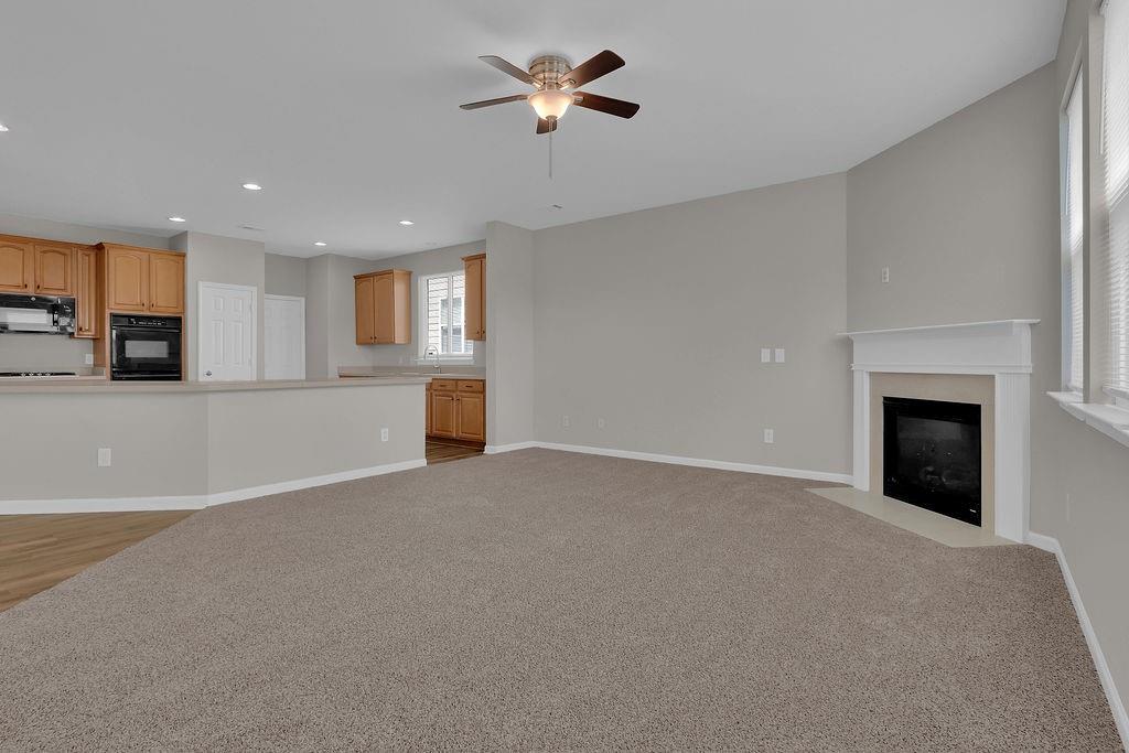 1978 Cutleaf Creek Road Southeast Grayson, GA 30017 - Photo 11 of 38 a view of a livingroom with a fireplace and a chandelier fan