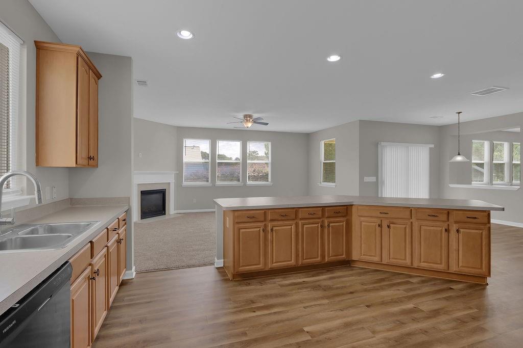 1978 Cutleaf Creek Road Southeast Grayson, GA 30017 - Photo 16 of 38 a large kitchen with stainless steel appliances granite countertop a sink dishwasher stove and wooden cabinets