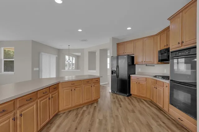 a kitchen with stainless steel appliances granite countertop a refrigerator sink and cabinets