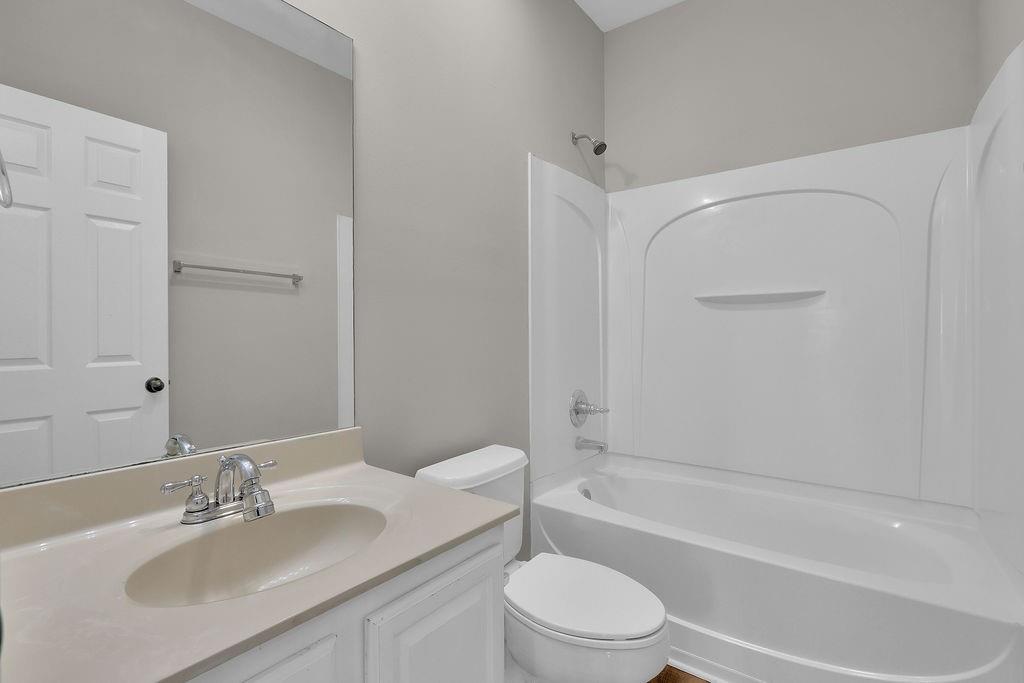 1978 Cutleaf Creek Road Southeast Grayson, GA 30017 - Photo 19 of 38 a bathroom with a granite countertop sink toilet and shower