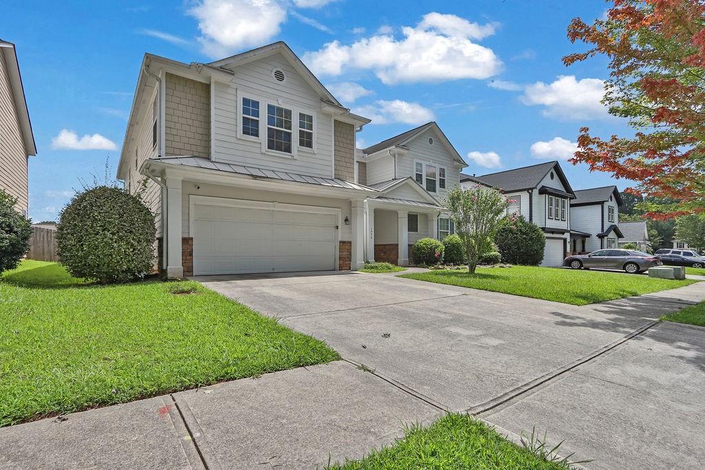 1978 Cutleaf Creek Road Southeast Grayson, GA 30017 - Photo 2 of 38 a front view of a house with a garden and plants